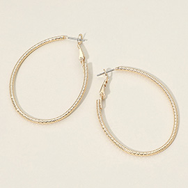 Gold Dipped Textured Oval Hoop Earrings